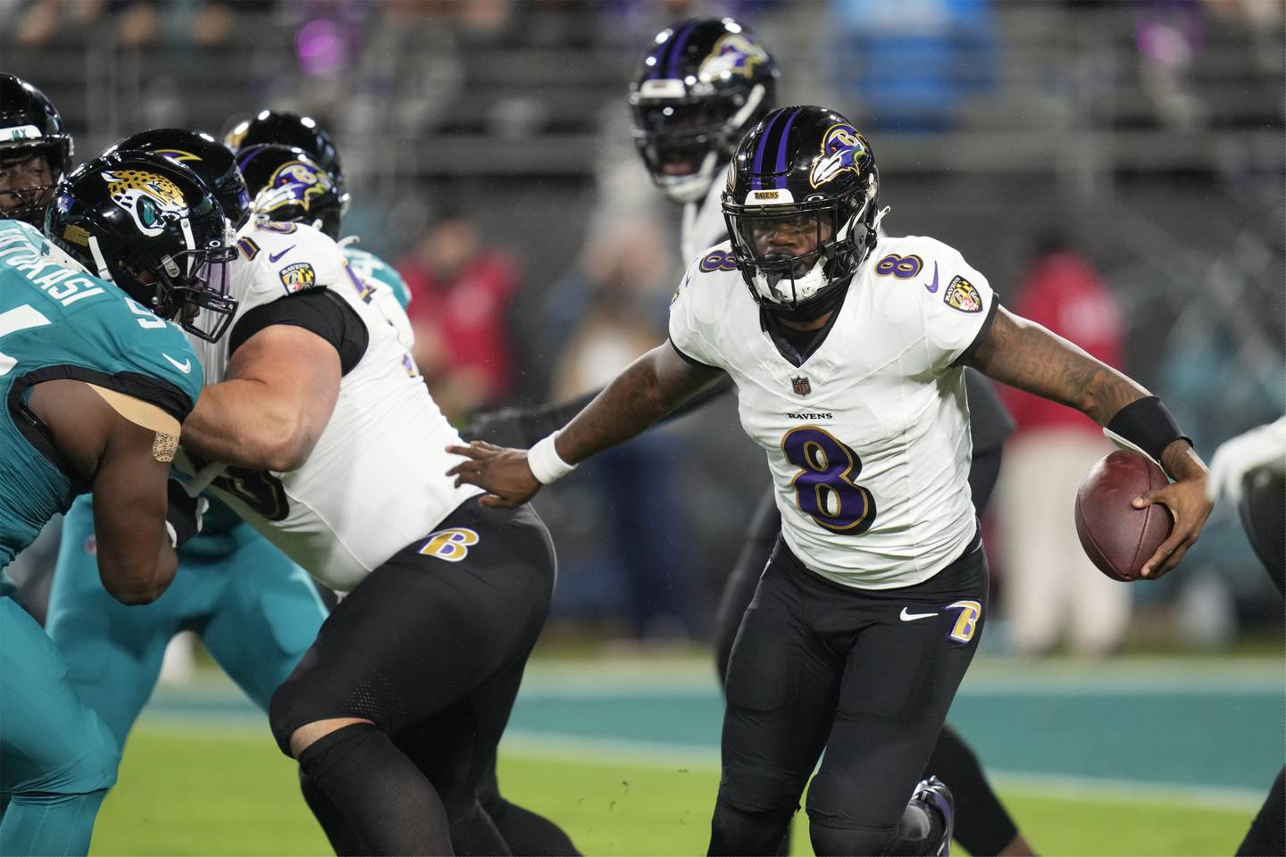 Baltimore Ravens quarterback Lamar Jackson (8) scrambles against the Jacksonville Jaguars in the first half of an NFL football game Sunday, Dec. 17, 2023, in Jacksonville, Fla.