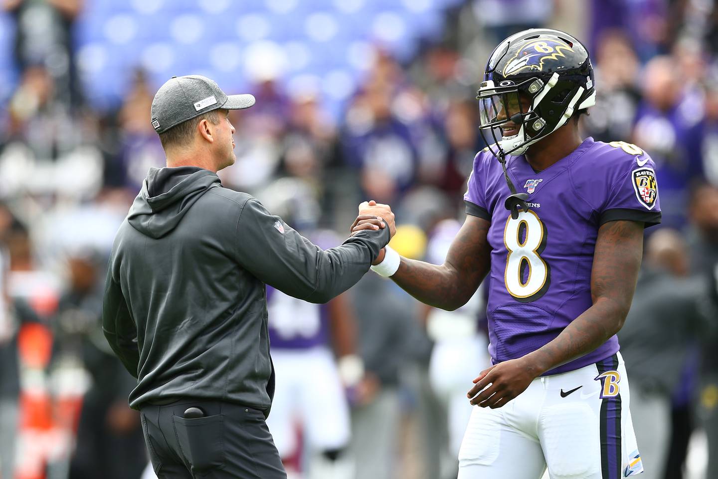 BALTIMORE, MD - OCTOBER 13: Head coach John Harbaugh interacts with Lamar Jackson #8 of the Baltimore Ravens prior to playing against the Cincinnati Bengals at M&T Bank Stadium on October 13, 2019 in Baltimore, Maryland.