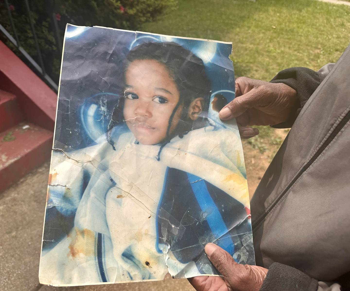 Otis Hughes holds a childhood picture of his grandson, Dabrae Edwards.