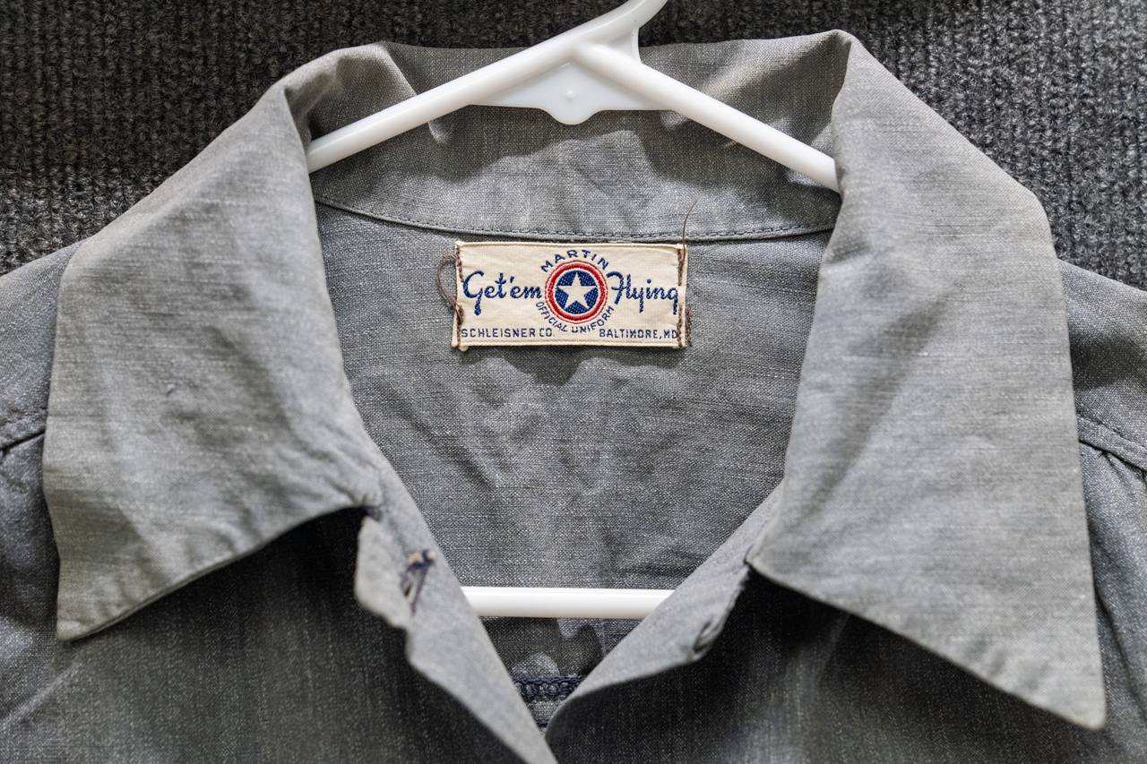 The tag of a gray 1943 Martin uniform blouse reads "Get 'em Flying".