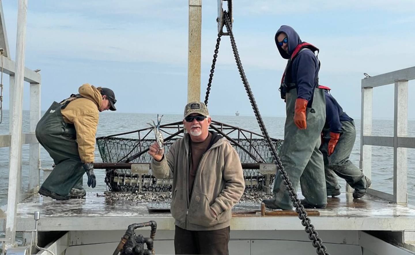 Capt. Roger Morris holds out a blue crab from the Chesapeake Bay dredged in January.