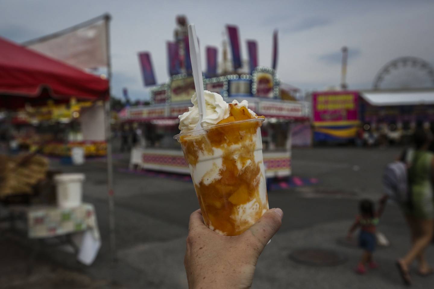 Farmer Stan of Green Meadows Farm shows off his original and sought after Peach Sundae at the Maryland State Fair on opening night in Timonium, MD on August 25, 2022.