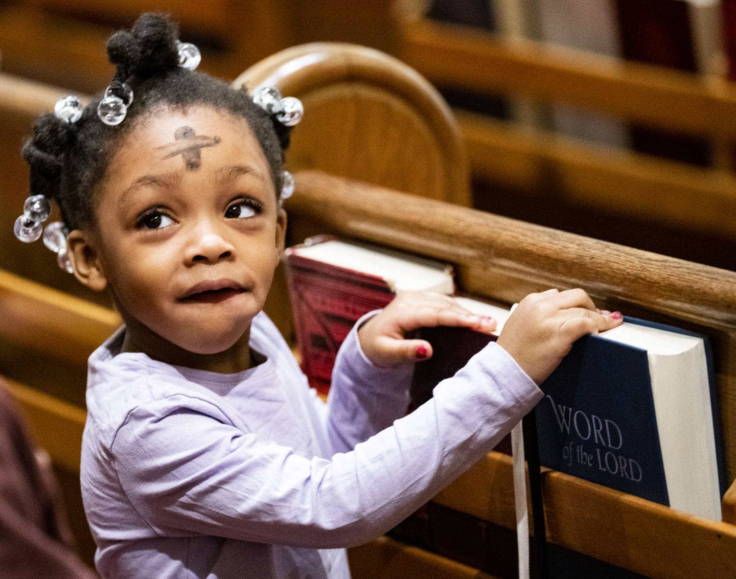 Lenno Bridgeforth, of Baltimore, looks through the pews at St. Francis Xavier Church during Ash Wednesday Mass, in Baltimore, Wednesday, February 22, 2023.