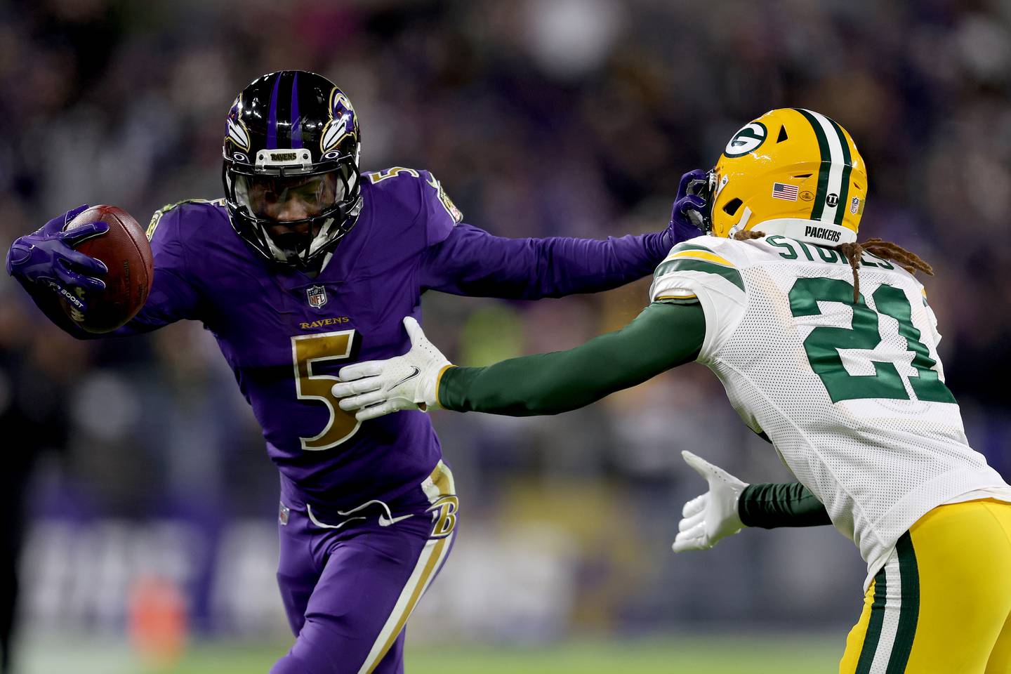 BALTIMORE, MARYLAND - DECEMBER 19: Marquise Brown #5 of the Baltimore Ravens runs with the ball after the catch against Eric Stokes #21 of the Green Bay Packers in the fourth quarter at M&T Bank Stadium on December 19, 2021 in Baltimore, Maryland.