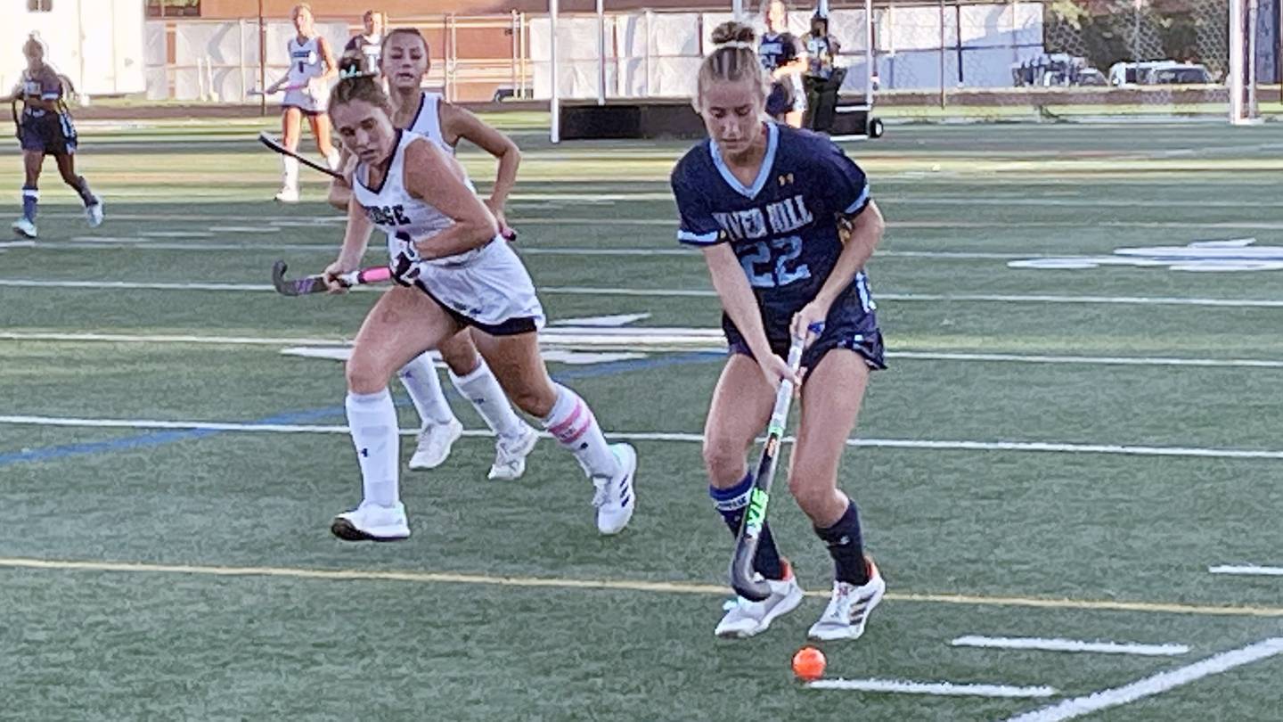 River Hill’s Maddie Vasilios (22) moves the ball downfield in Wednesday’s 6-3 win at No. 8 Marriotts Ridge. A senior headed for Maryland, Vasilios scored four goals as the No. 7 Hawks remained undefeated against Howard County competition.