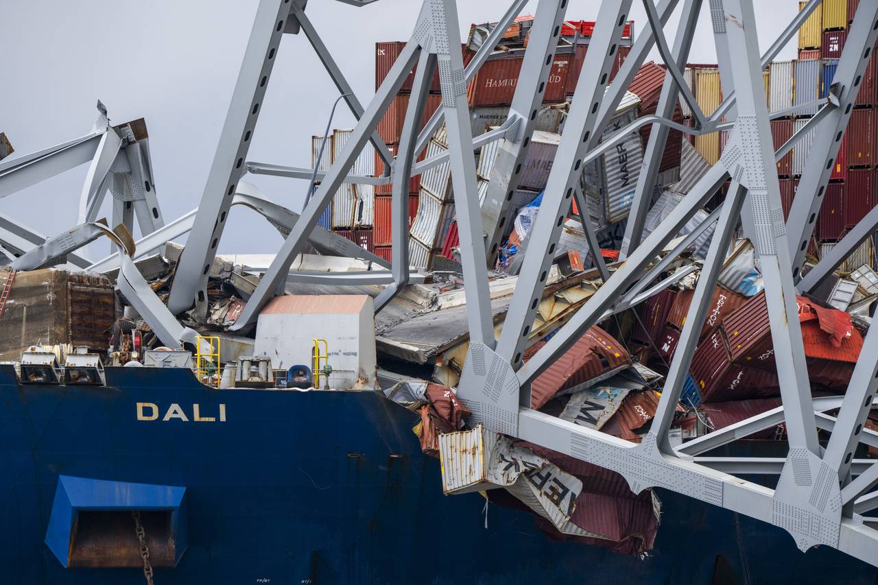 The site of the collapsed Key Bridge and the container ship that toppled it, the Dali, are seen from a debris retrieval vessel, The Reynolds, on April 4, 2024.
