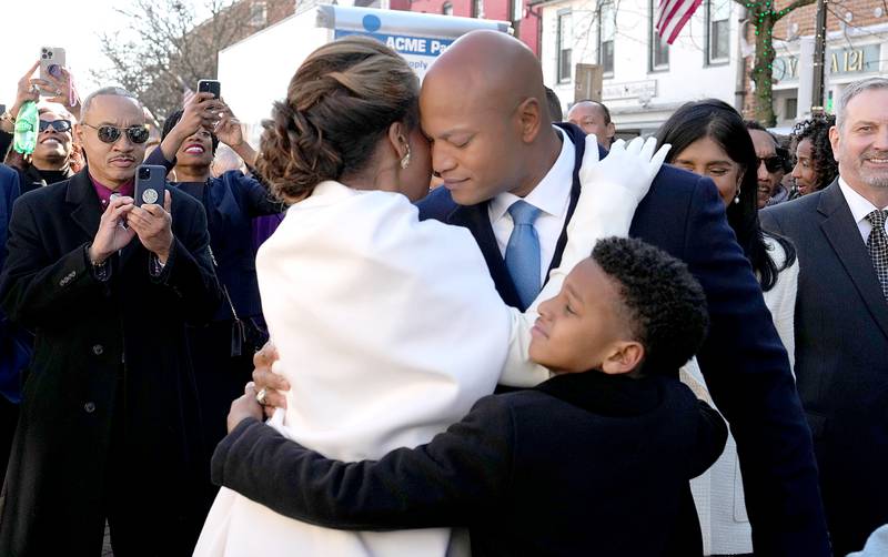 Dawn Flythe Moore and James Moore hug Gov.-elect Wes Moore as they depart from the Kunta Kinte-Haley Memorial, where they laid a wreath and said a prayer before the governor-elect was sworn in as the first African American governor of the state of Maryland.
