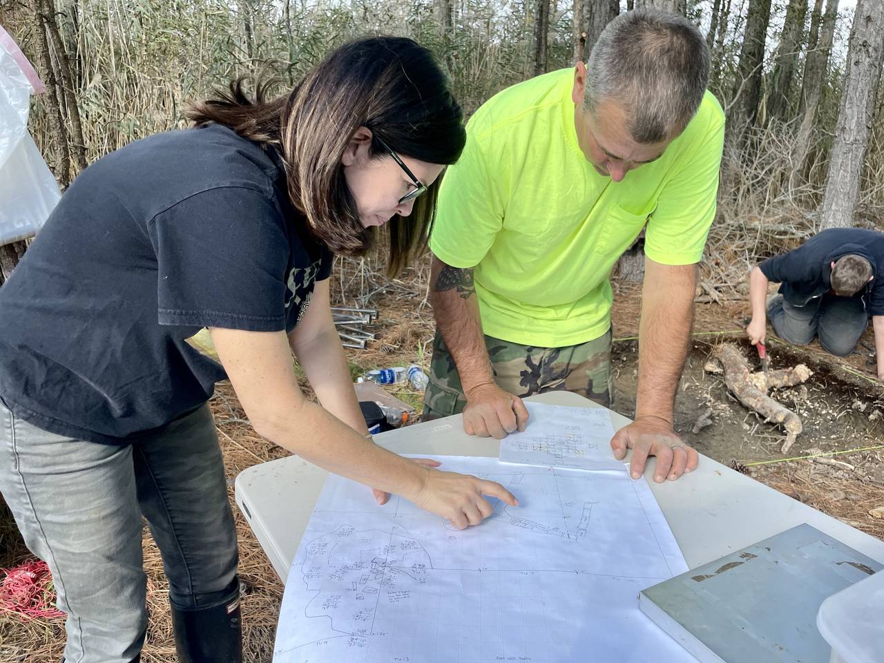 MDOT archaeologists Julie Schablitsky and Aaron Levinthal examine a map to determine where to dig next at the site of Ben Ross’ cabin.