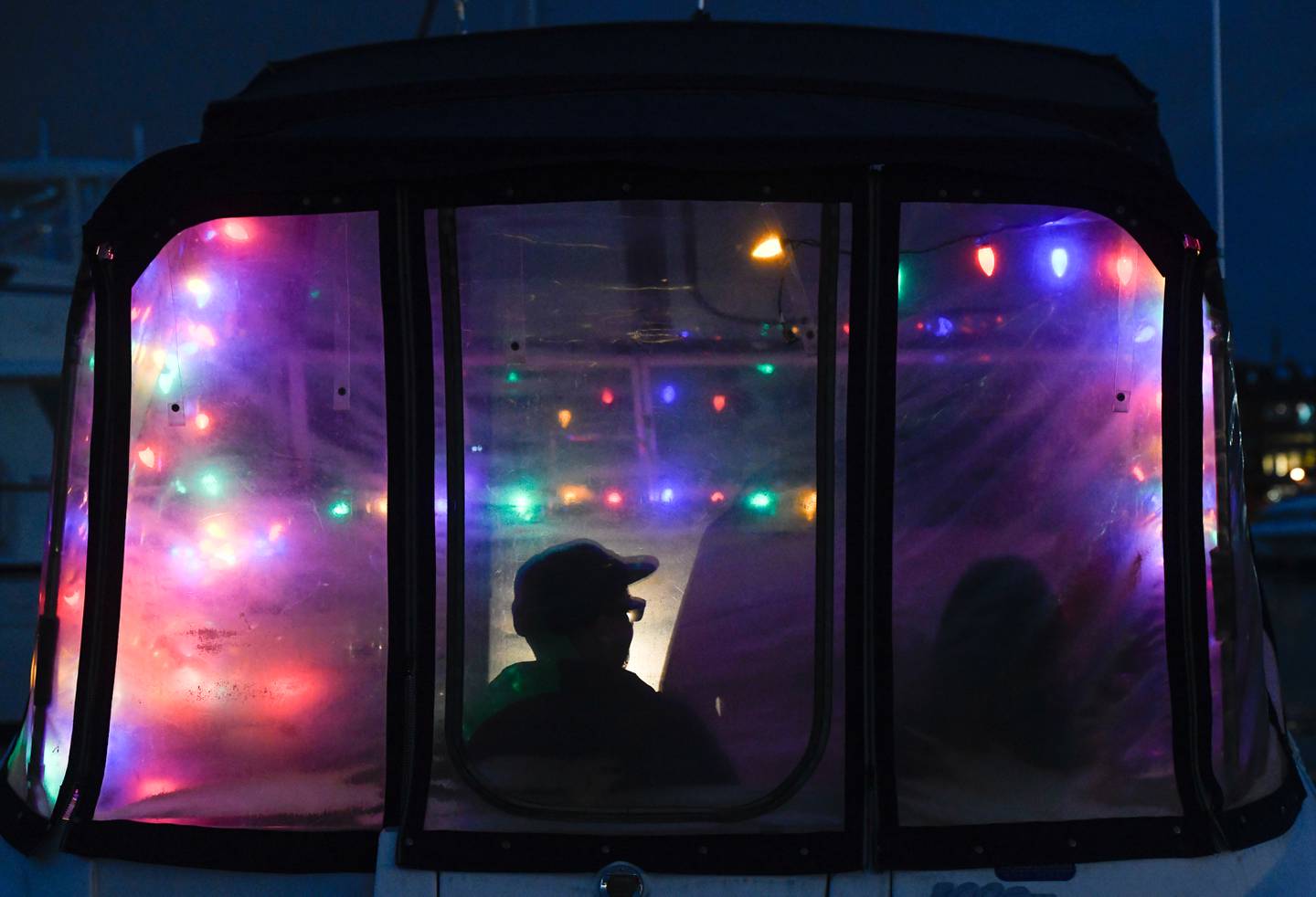 Andrew Herr, who lives in Lancaster, Pa. but spends most of his weekends in Baltimore, waits in his boat at Anchorage Marina in Canton for the start of the Baltimore Lighted Boat Parade, Saturday, Dec. 3, 2022.