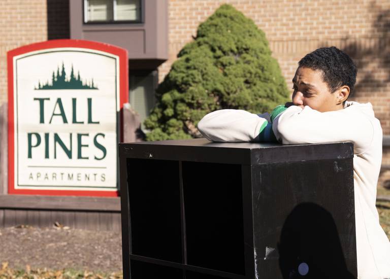 Sharnae Hunt watches as packers put her belongs back onto a truck after being wrongfully evicted at Tall Pines apartment, in Glen Burnie, Tuesday, November 22, 2022.