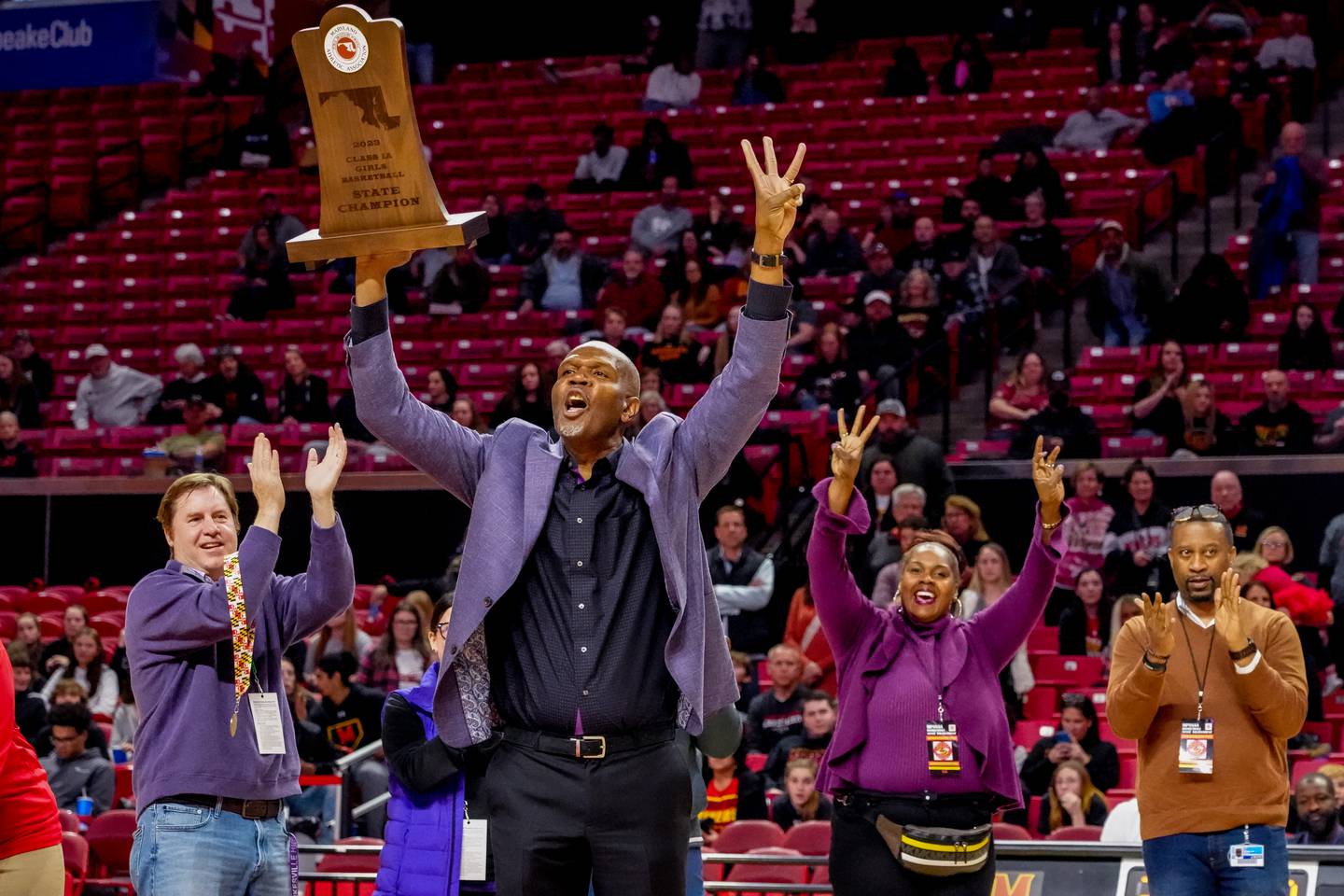 Pikesville Head Coach Michael Dukes celebrates his team's third straight state title (not including the COVID-year gap in between) after winning the MPSSAA High School 1A Girls Championship between Pikesville and Mountain Ridge at Xfinity Center on the University of Maryland campus in College Park.