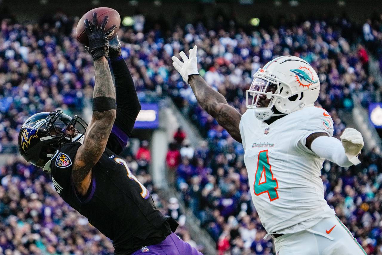 Baltimore Ravens wide receiver Odell Beckham Jr. (3) catches a pass as Miami Dolphins cornerback Kader Kohou (4) tries to block during the second quarter at M&T Bank Stadium on Sunday, Dec. 31, 2023.