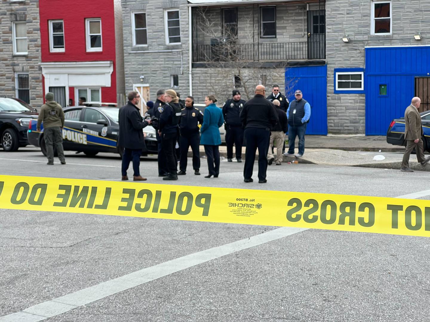 Baltimore Police officers stood at a scene in the 2000 block of West Pratt Street on Dec. 30, 2023, in response to an officer involved shooting.