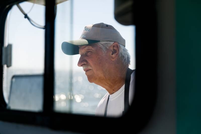 JC Hudgins watches for his crab pot buoys while pulling pots out of the water in Mathews, Va., on Friday, June 10, 2022.