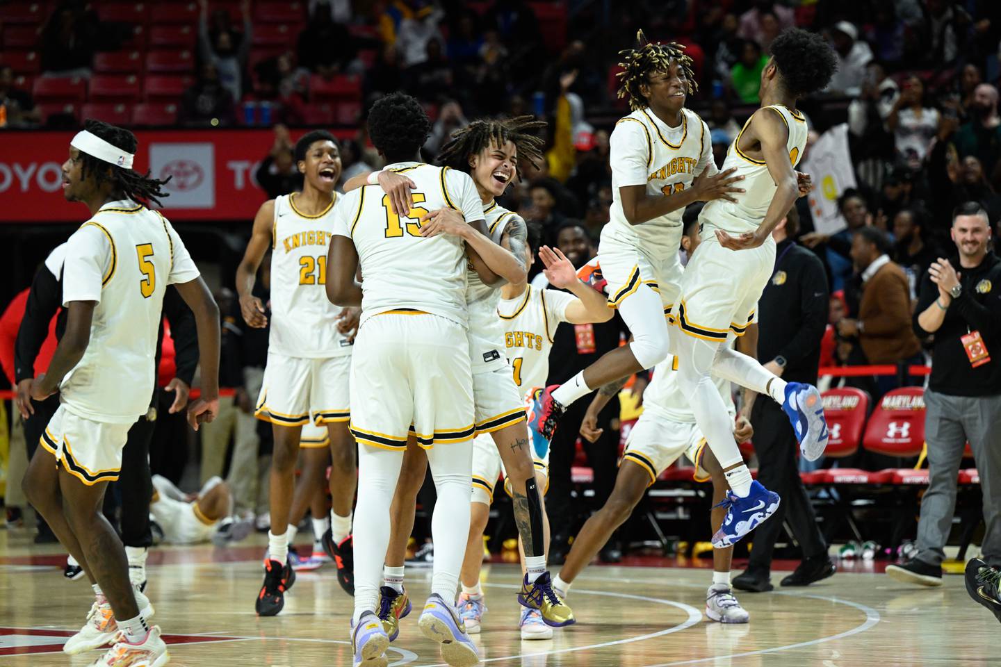 Parkville Knights players celebrate winning the MPSSAA 4A Boys state basketball final against the Meade Mustangs, Saturday, March 11, 2023, in College Park.