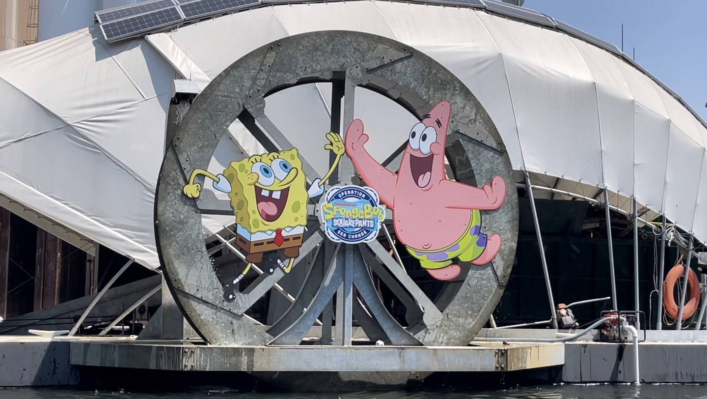 SpongeBob Squarepants and Patrick Star smile and wave on Gwynnda the Good Wheel of the West.