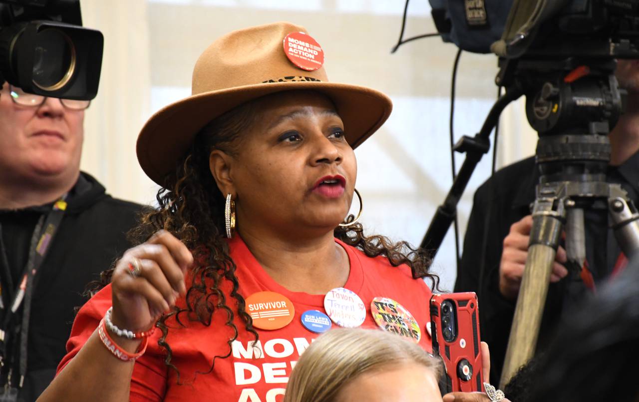Denise Reid, a volunteer with Moms Demand Action, speaks to Gov. Wes Moore during a press conference at the State House in Annapolis on Tuesday, Jan. 9, 2024. Moore announced proposals to improve public safety.