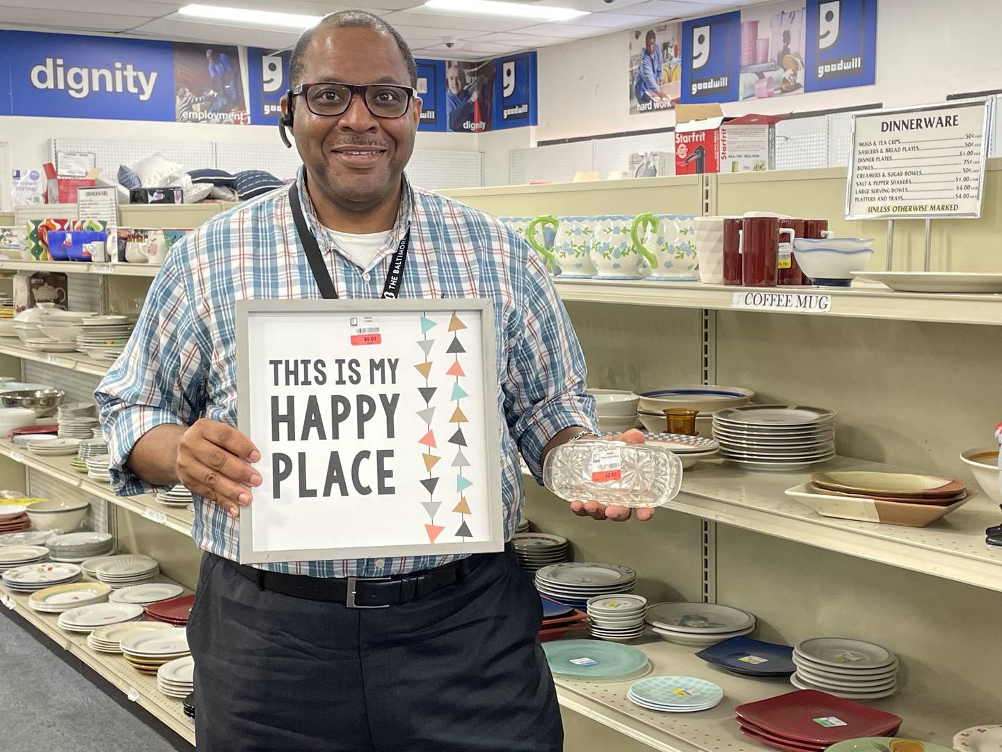 Baltimore Banner Executive Assistant Uhmar Alston stands with some treasures he later purchased at the Goodwill Super Store at 11411 Reisterstown Rd in Owings Mills on August 26, 2022.