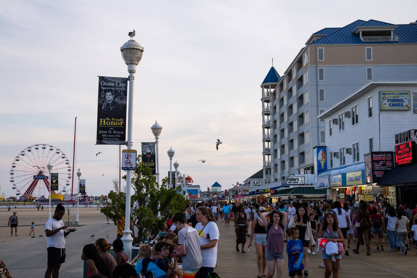 People walk along the Ocean City Boardwalk.