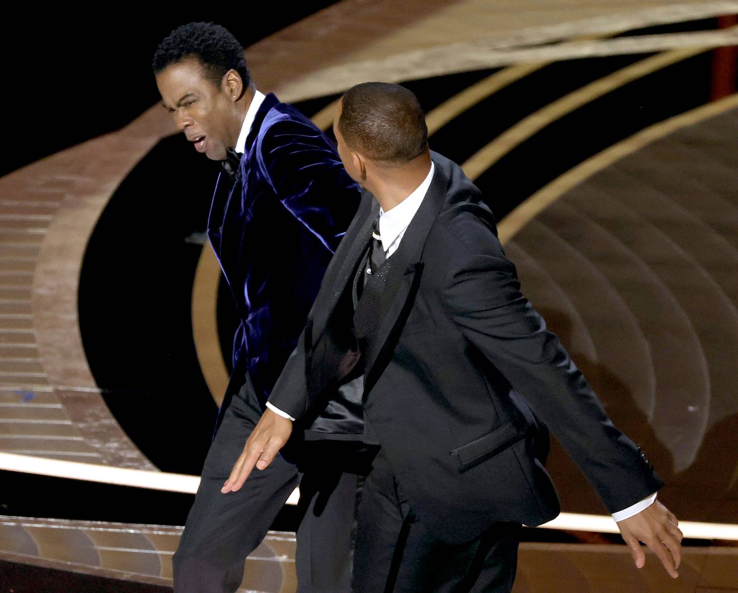HOLLYWOOD, CALIFORNIA - MARCH 27: Will Smith appears to slap Chris Rock onstage during the 94th Annual Academy Awards at Dolby Theatre on March 27, 2022 in Hollywood, California.