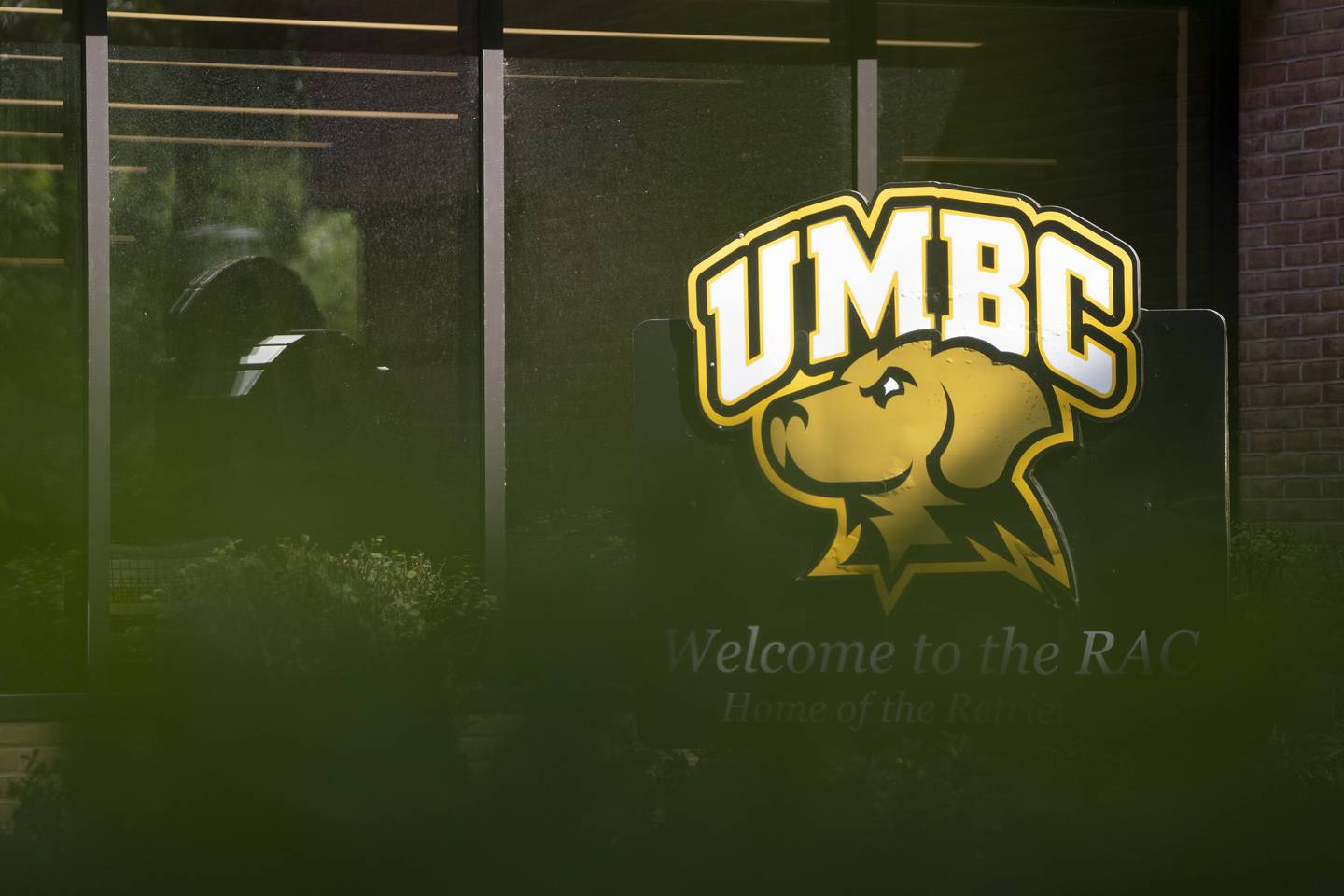 The UMBC mascot and logo outside of the Retriever Activities Center.