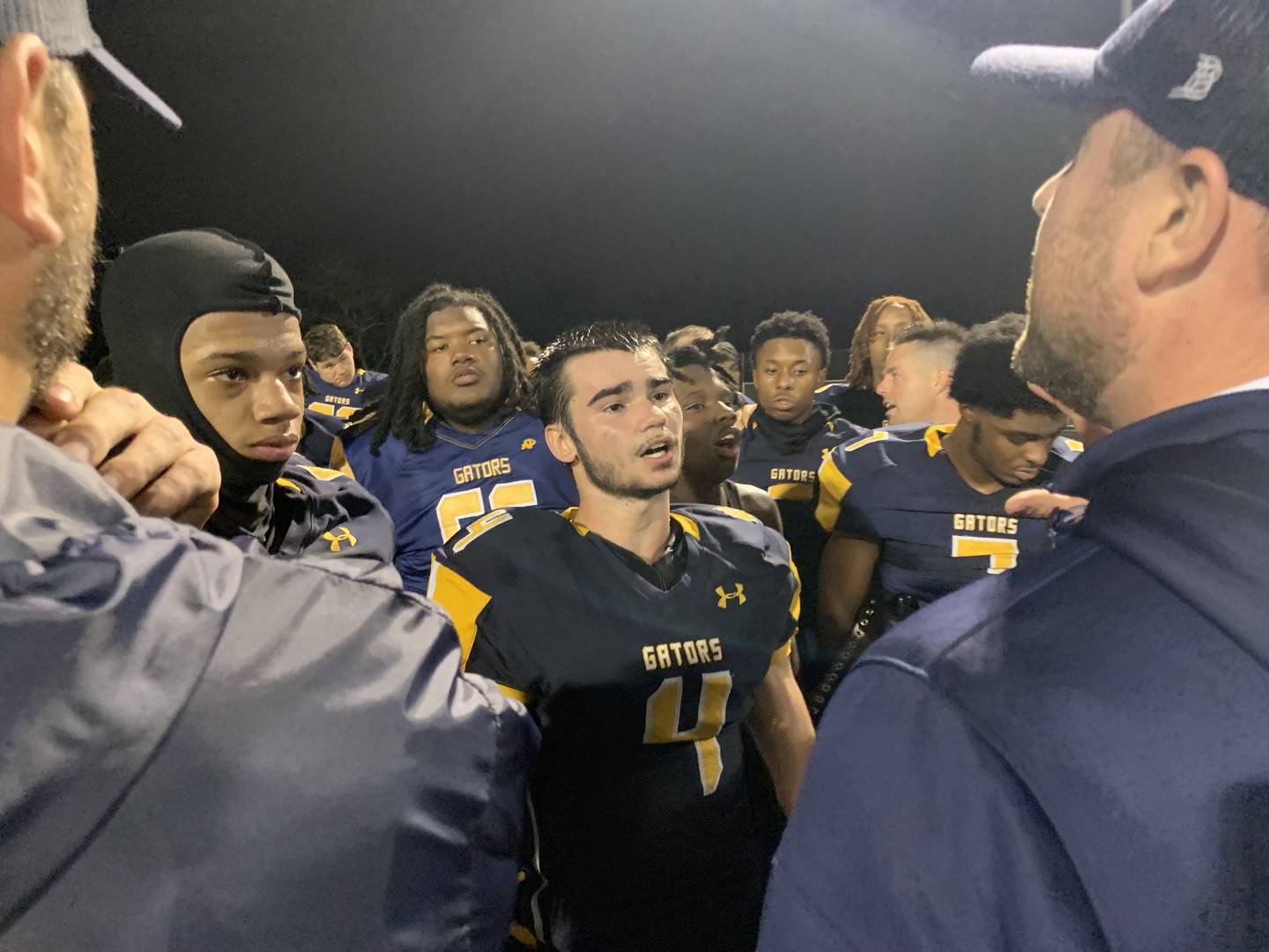 With Jacob Wagner in the middle, Perry Hall football players listen to their coaches after Friday's victory over Mervo. The Gators ended Mervo's bid for a second straight Class 4A/3A state title with a 7-6 victory in the second round of the North Region playoffs.