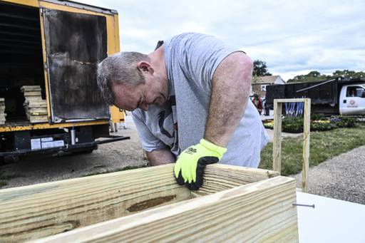 A volunteer builds a flower box at the Brooklyn Healing Day on Saturday.