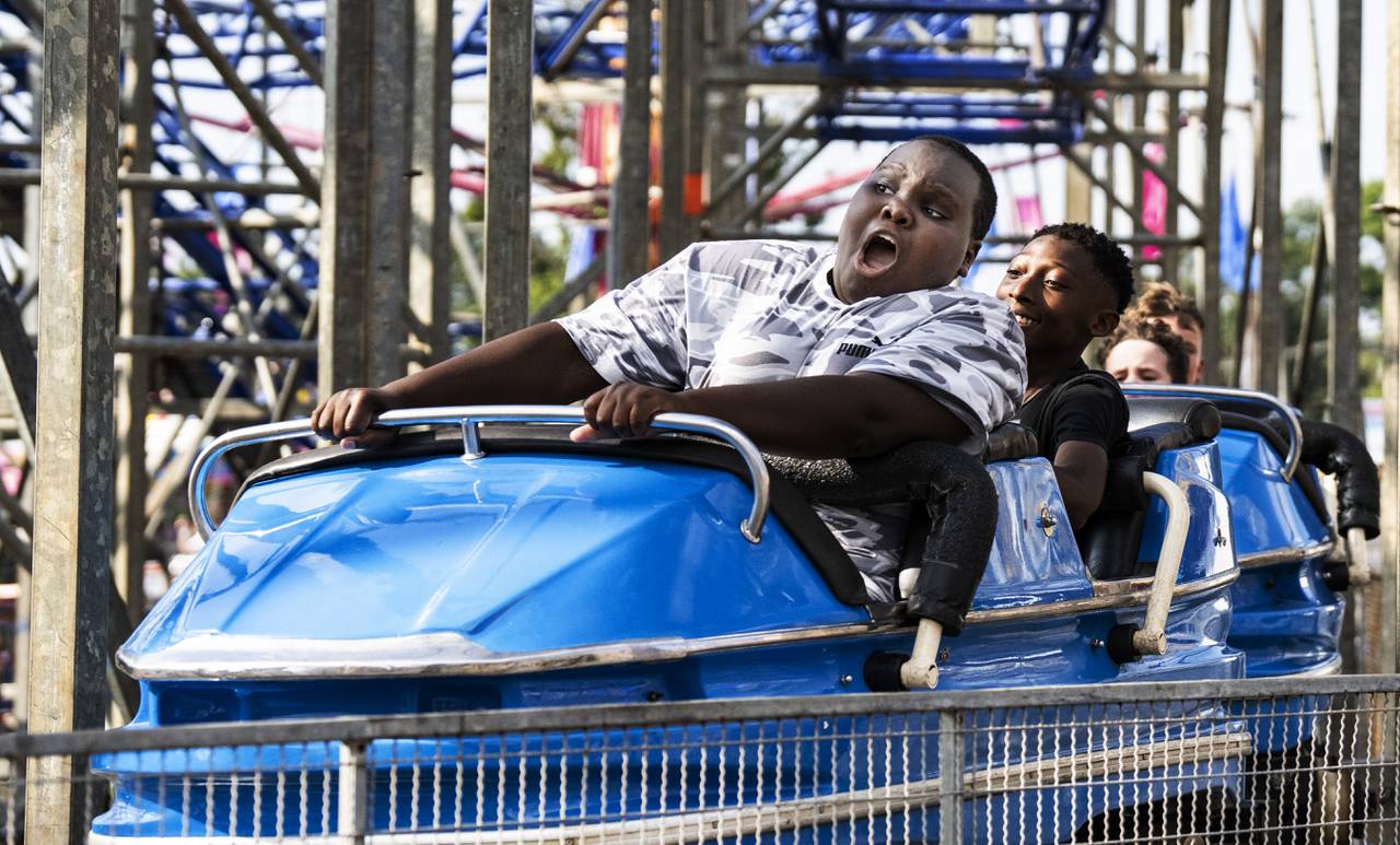 Emmanuel Sofowora, 12, of Baltimore hits are hard turn on a rollercoaster at the Maryland State Fair, in Timonium, Friday, August 25, 2023.