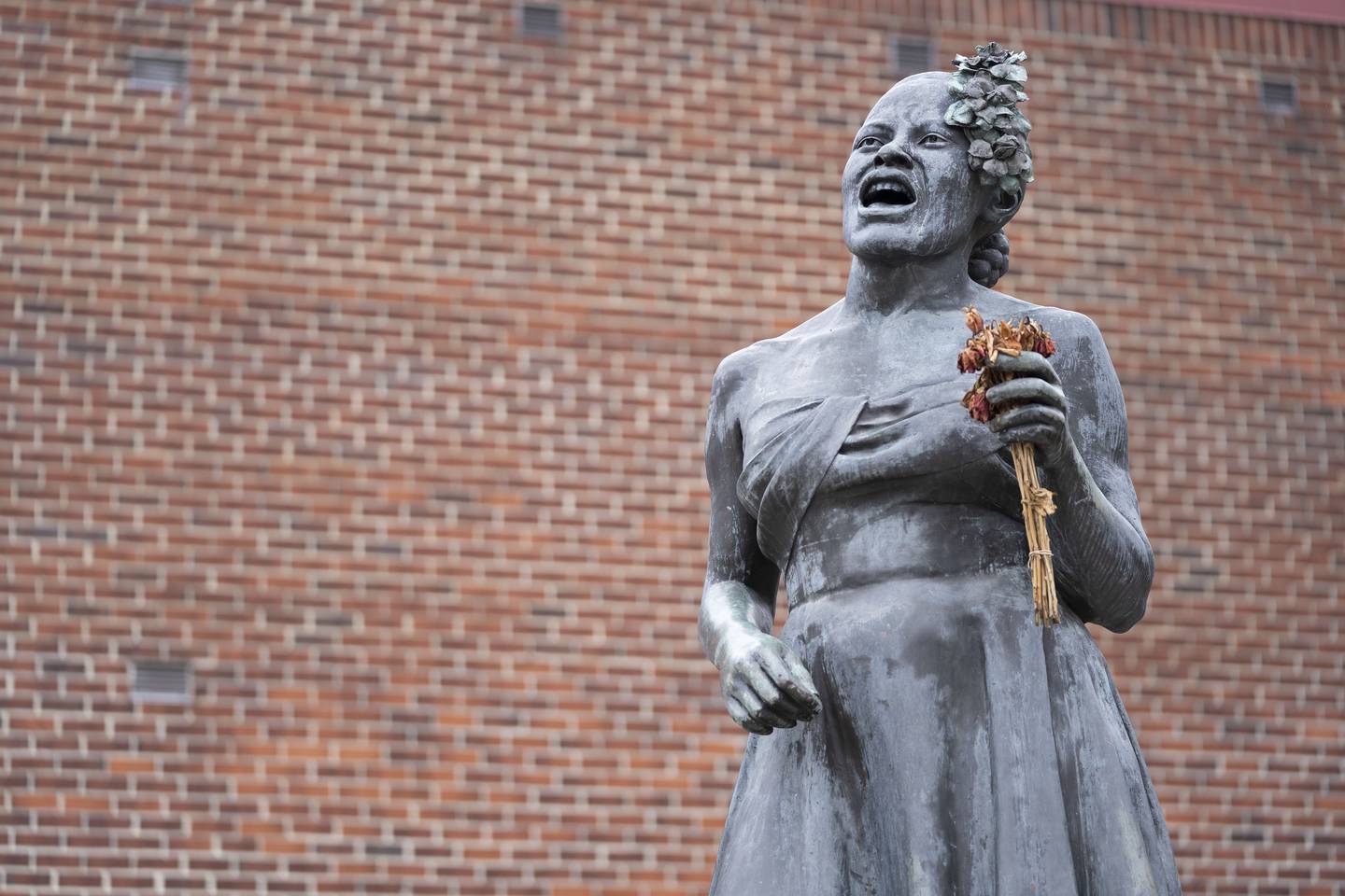 The Billie Holiday statue holds dry flowers near the intersection of Pennsylvania Avenue and West Lafayette Avenue.