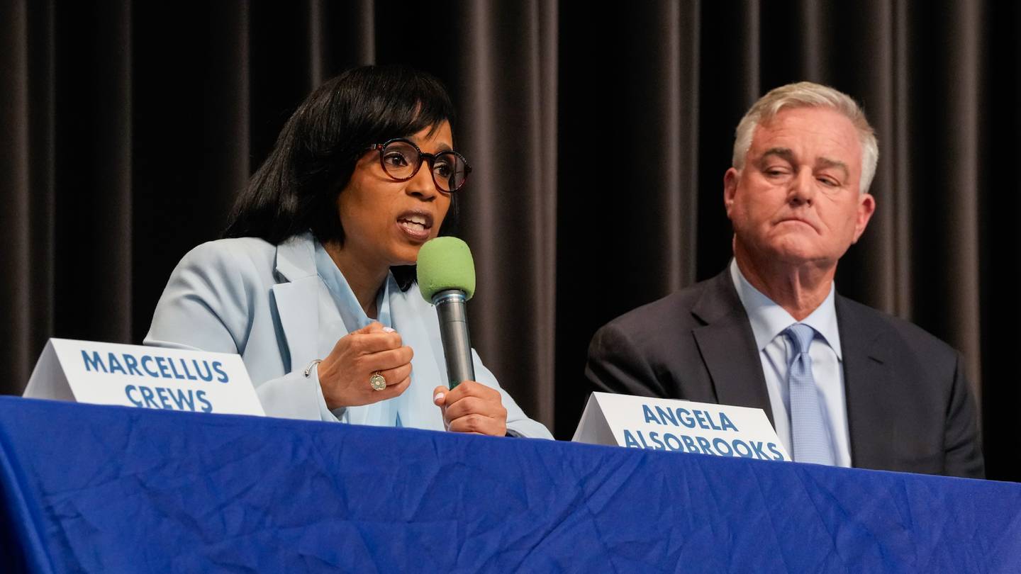 Prince George's County Executive Angela Alsobrooks speaks as U.S. Rep. David Trone listens during a forum with other U.S. Senate candidates at Montgomery Blair High School in Silver Spring, Maryland on Saturday, March 2, 2024.