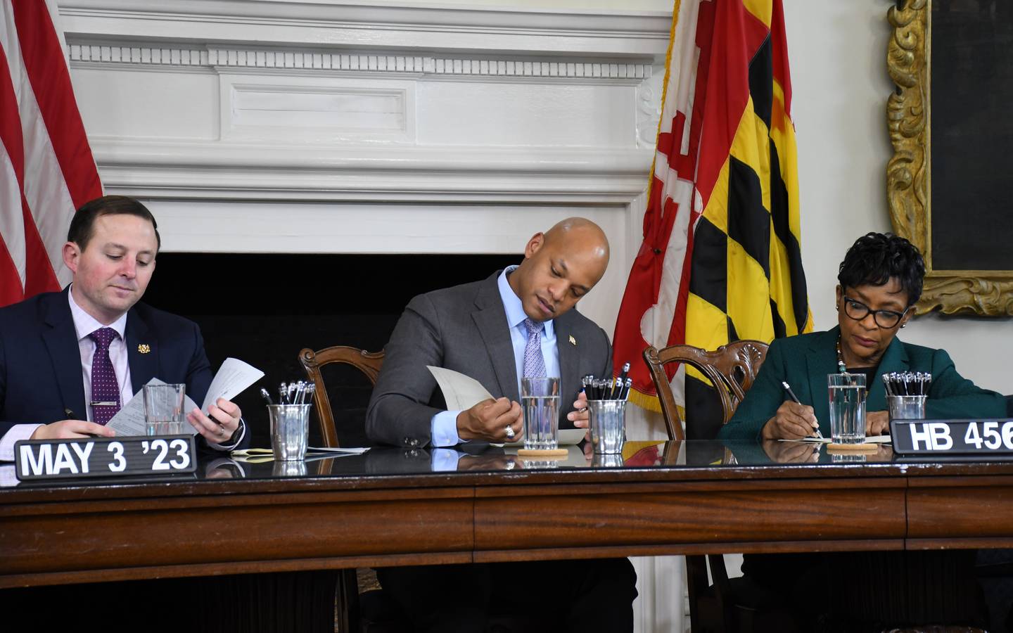 Maryland Senate President Bill Ferguson, left, Gov. Wes Moore and House of Delegates Speaker Adrienne A. Jones sign dozens of bills into law during a ceremony at the State House in Annapolis on Wednesday, May 3, 2023.