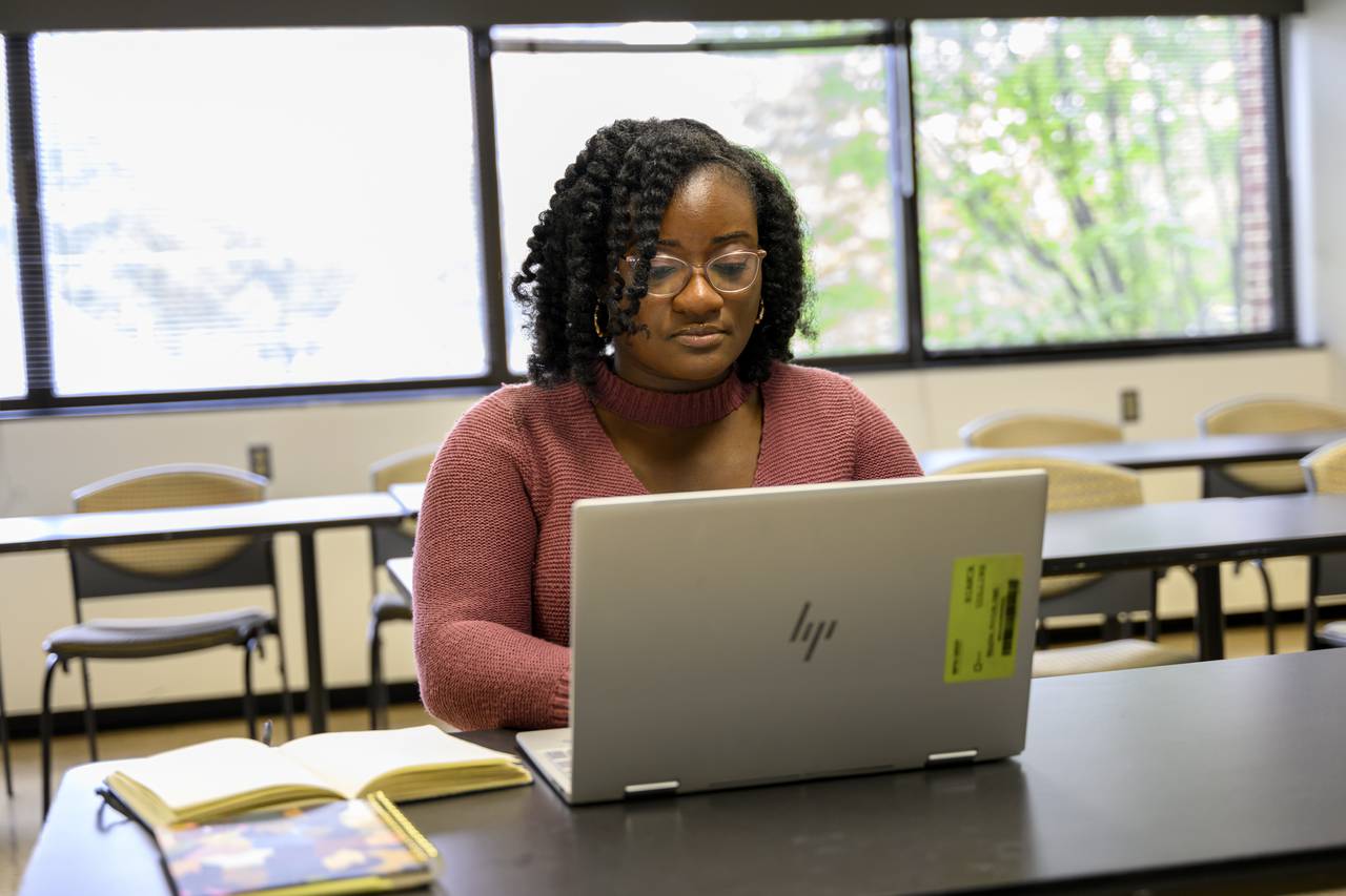 Bianca Collins, a member of the first cohort of a new fellowship for school-based mental health jointly offered by the University of Maryland and Coppin State University, studying in a classroom at the  school of social work at UMB where she is in her last year of earning a Master's degree, on September 25, 2023.
