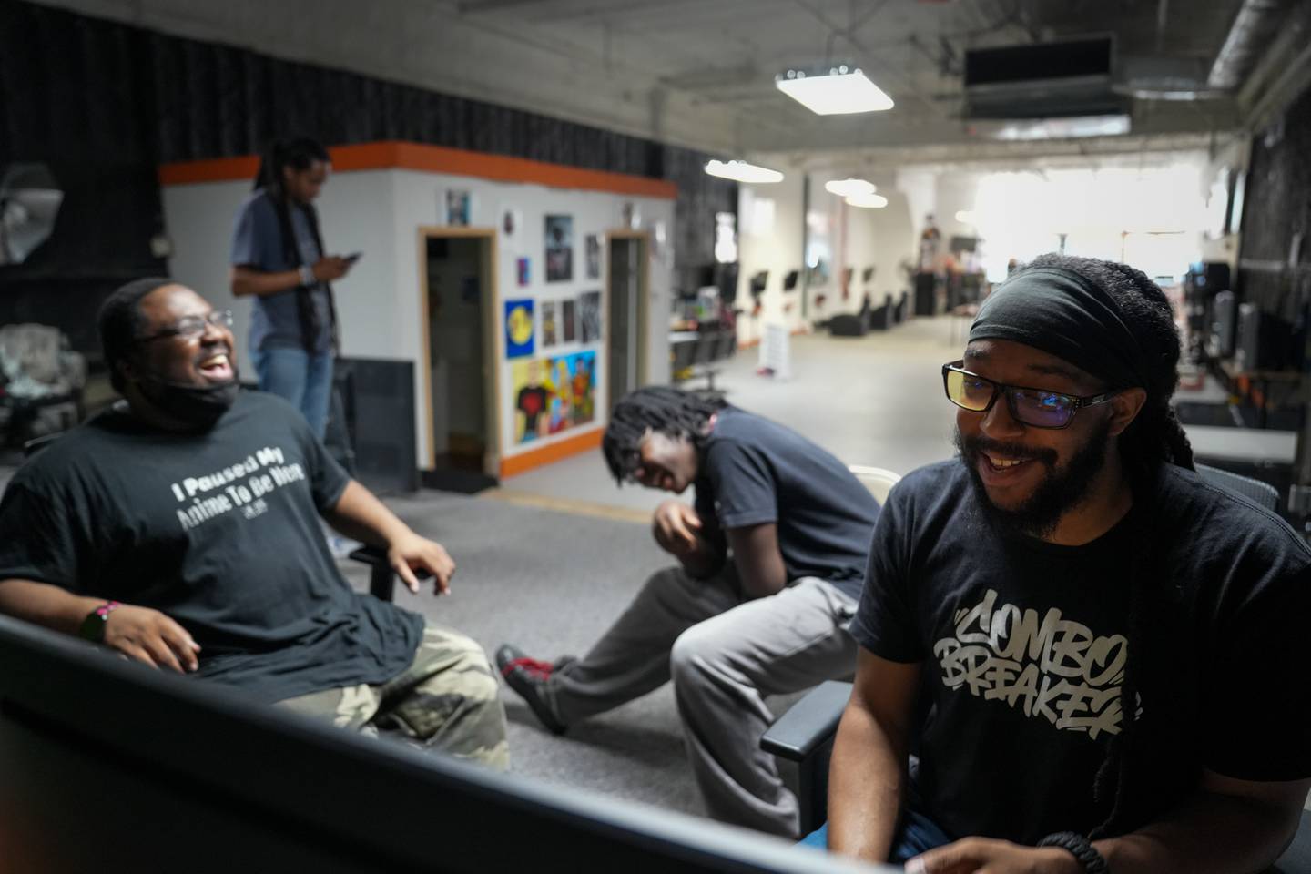 Carl Lloyd, Heavin Jackson and Duane Hinton laugh while playing games at M.A.P. Technologies in downtown Baltimore on 6/11/22.