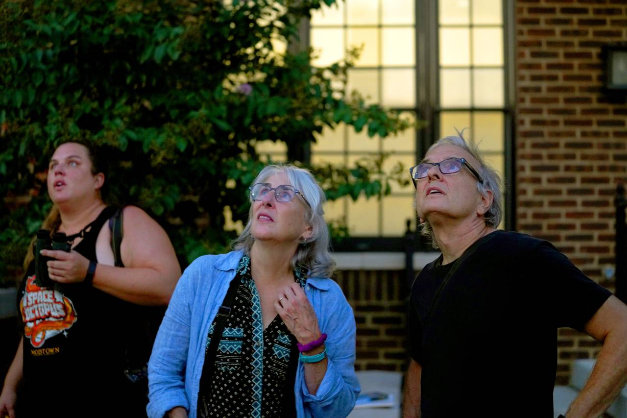 (L to R) Libby Erickson, Alice Greely-Nelson and husband David Nelson gather to watch the chimney swifts gather for the night  in Hampden's old bookbindery as they journey from Canada to South America. This year, could be the last as the building has been purchased and possibly slated for demolition.