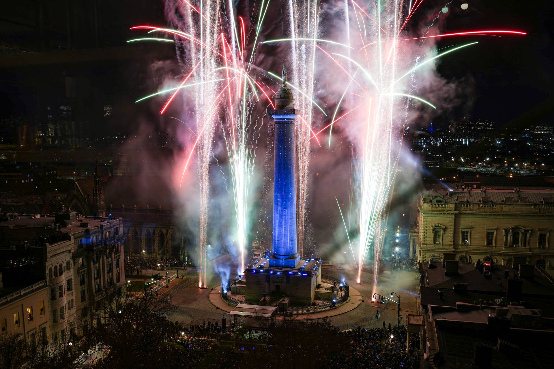 Fireworks light up the sky around the Washington Monument during the 52nd Monument Lighting at Mount Vernon Place on Thursday, December 7, 2023.