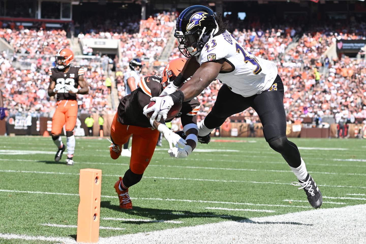 CLEVELAND, OHIO - OCTOBER 01: Juan Thornhill #1 of the Cleveland Browns knocks Melvin Gordon III #33 of the Baltimore Ravens out of bounds short of the end zone during the third quarter at Cleveland Browns Stadium on October 01, 2023 in Cleveland, Ohio. (Photo by Nick Cammett/Getty Images)