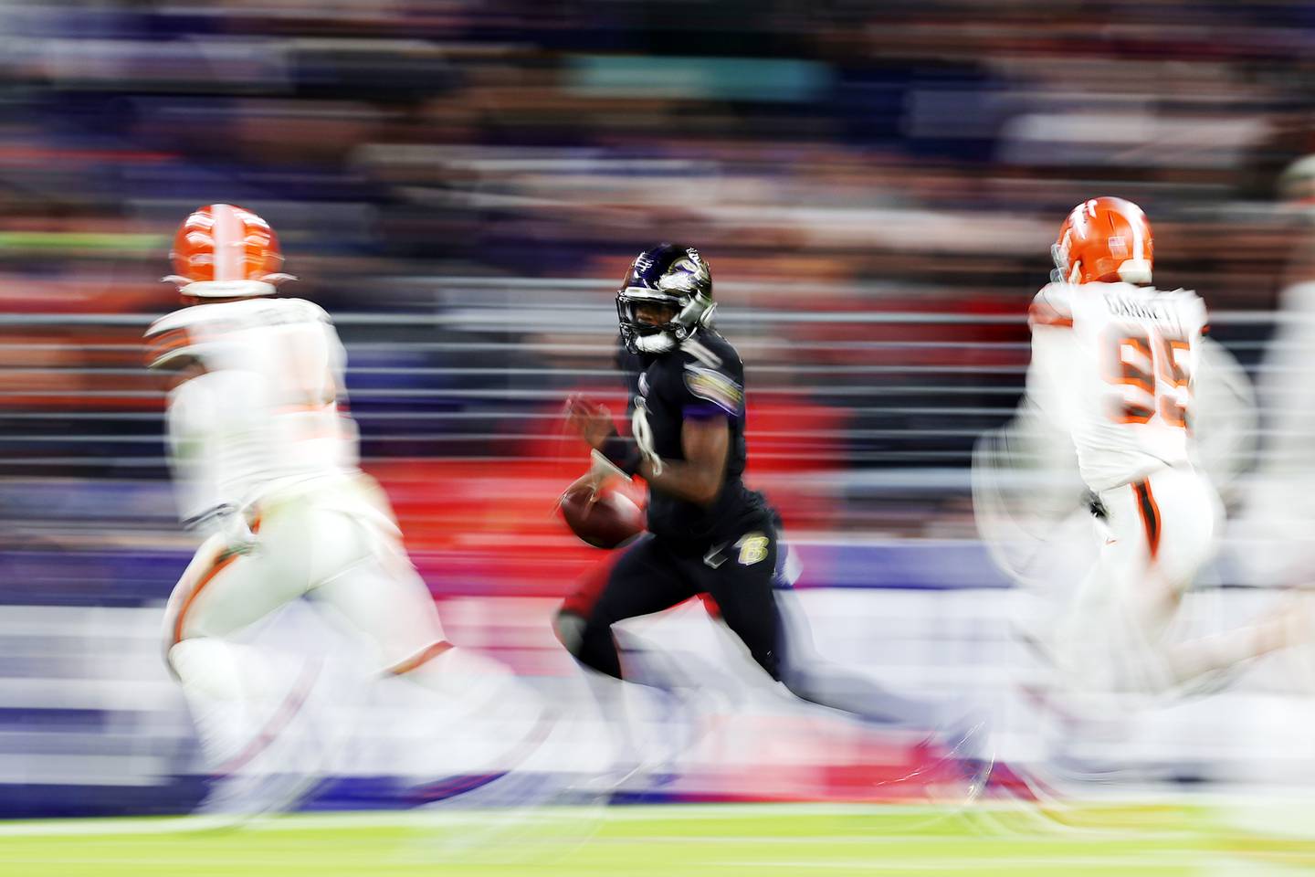 Lamar Jackson #8 of the Baltimore Ravens scrambles during a game against the Cleveland Browns at M&T Bank Stadium on November 28, 2021.
