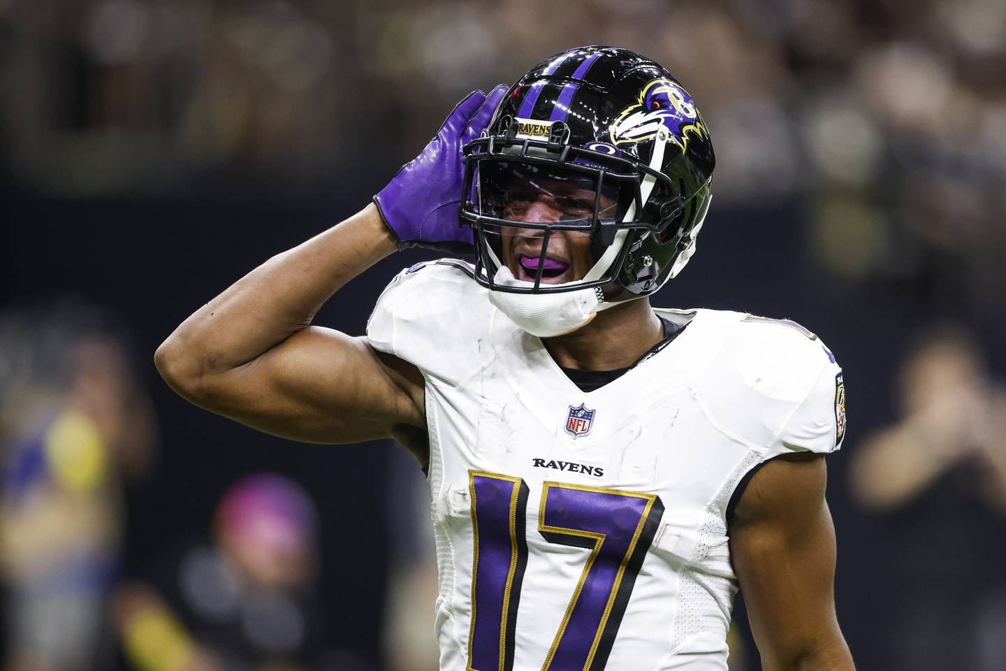 This photo shows Baltimore Ravens running back Kenyon Drake holding his hand up to his ear as he celebrates scoring a touchdown.