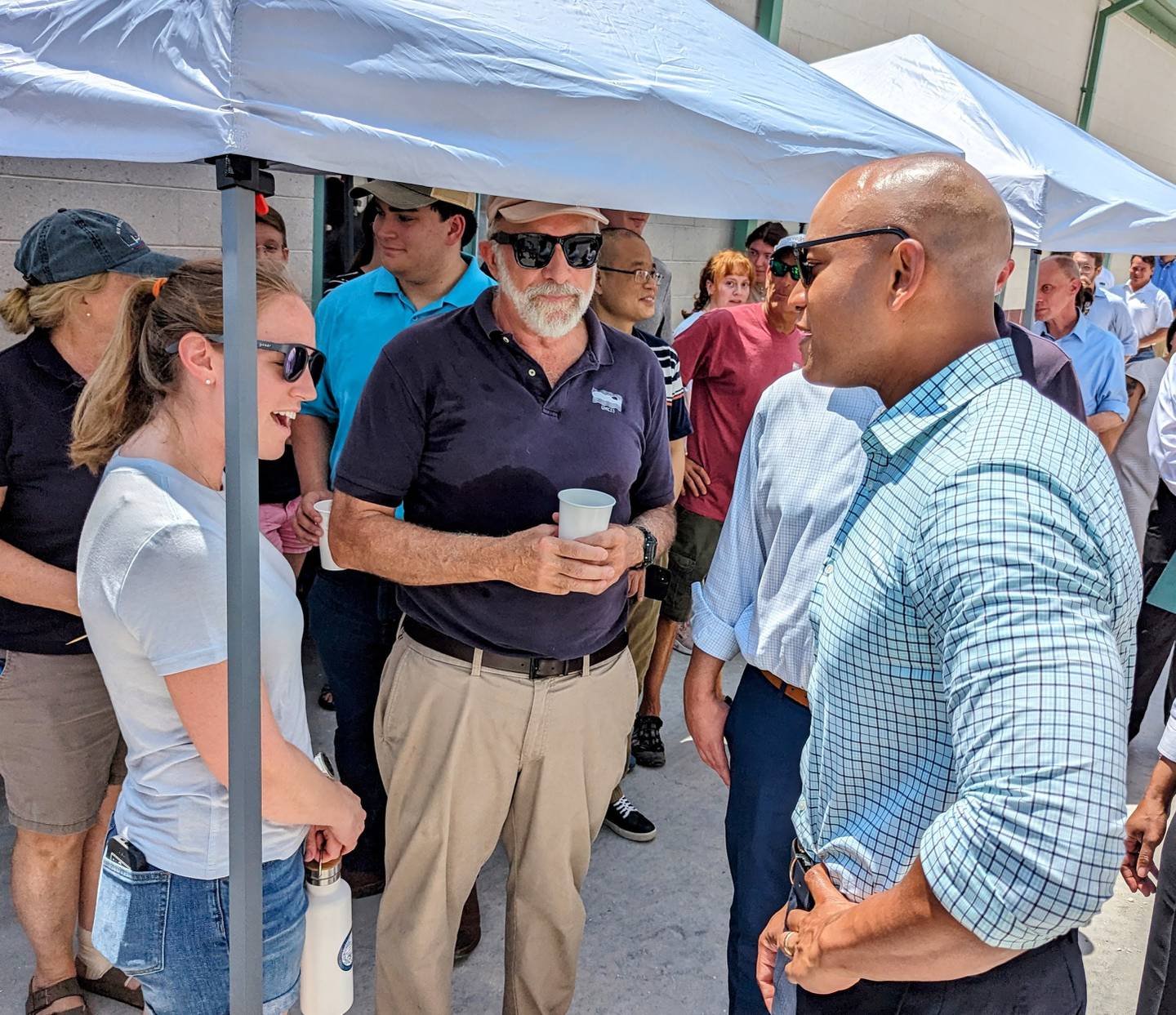 Christine Knauss, left, talks with Gov. Wes Moore as during a visit to the University of Maryland Center for Environmental Science as incoming director Bill Dennison listens at Horn Point on Thursday, July 20, 2023.