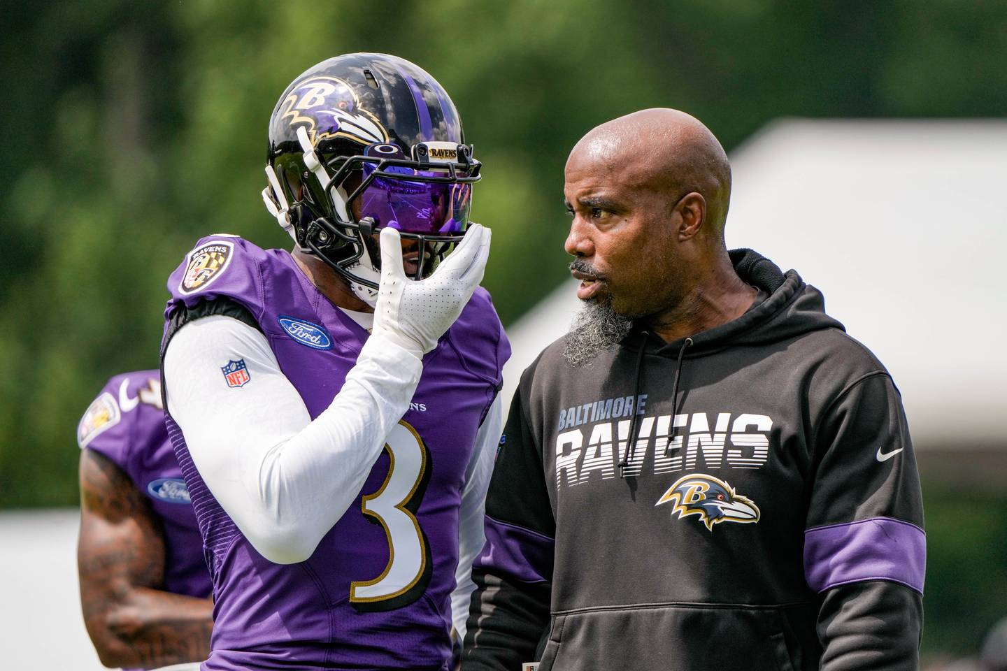 Ravens WR Odell Beckham Jr. talks to assistant WR coach Keith Williams at the first Ravens practice of the season on July 26, 2023.