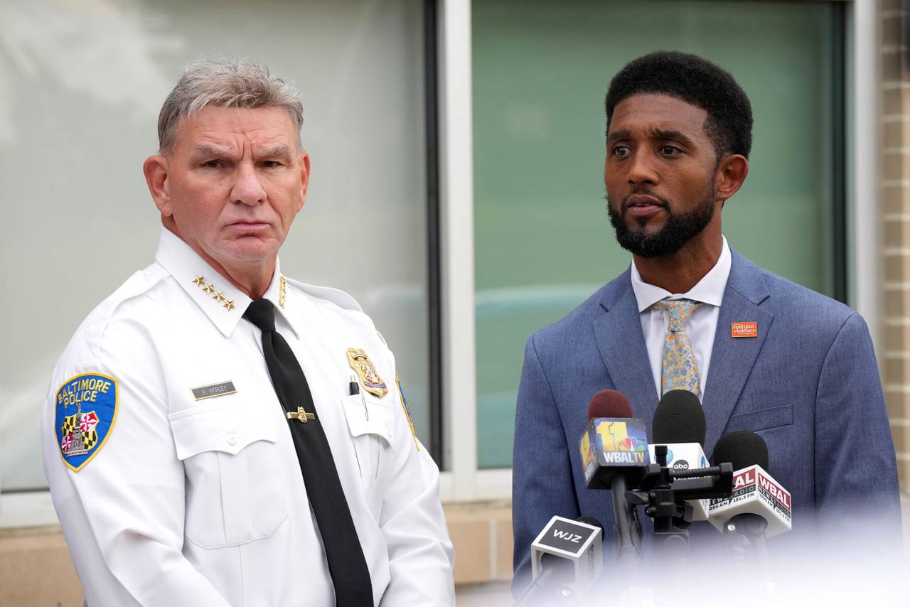 Acting Baltimore Police Commissioner Richard Worley, left, and Baltimore Mayor Brandon Scott take questions from reporters outside Bay-Brook Elementary/Middle School in Brooklyn Thursday before hosting a community meeting.
