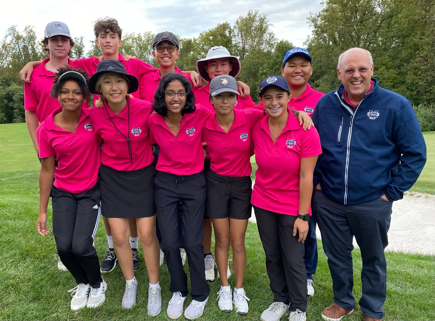 Marriotts Ridge golf coach Mark Dubbs poses with his boys and girls Howard County championship teams. The Mustang girls completed their third straight undefeated season, while the boys extended their win streak, which began in 2013, to 89 consecutive matches.