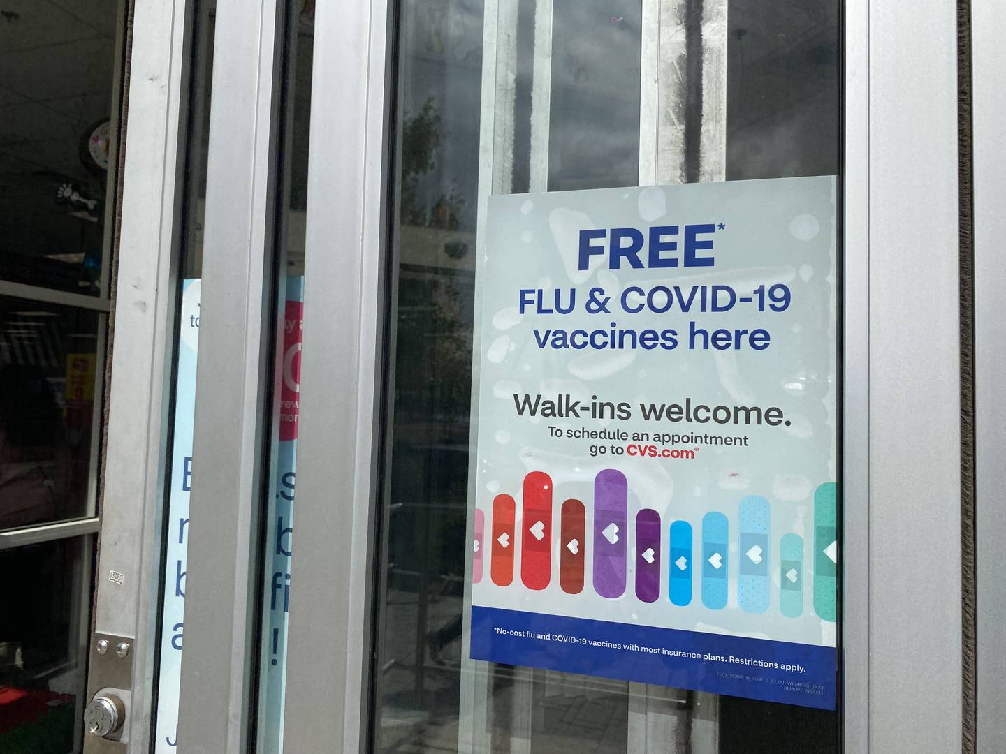COVID-19 vaccines are advertised at pharmacies across the region, but they're in short supply.