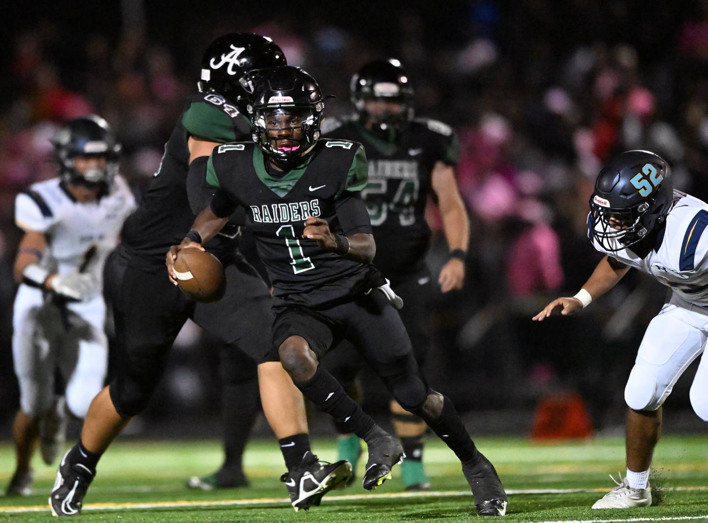 Atholton quarterback Miles Scott looks for running space during Howard County football contest against River Hill