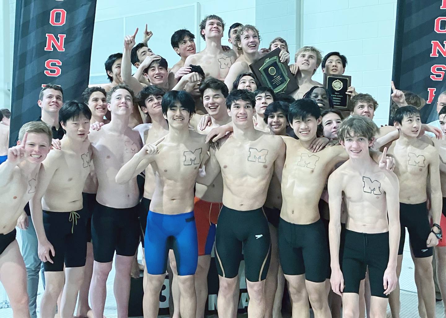 The McDonogh boys swimming team poses with the MIAA A Conference championship plaque following its impressive victory in the league's championship meet, Saturday at the Loyola University in Maryland Mangione Aquatic Center.