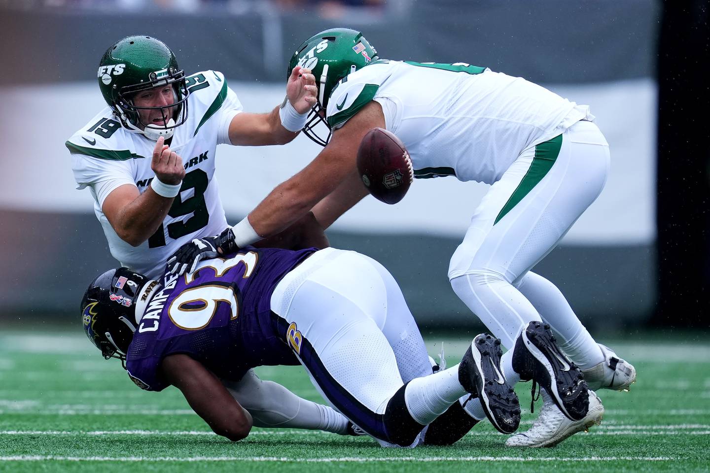 Joe Flacco #19 of the New York Jets called for intentional grounding after being pressured by Calais Campbell #93 of the Baltimore Ravens at MetLife Stadium on September 11, 2022 in East Rutherford, New Jersey.