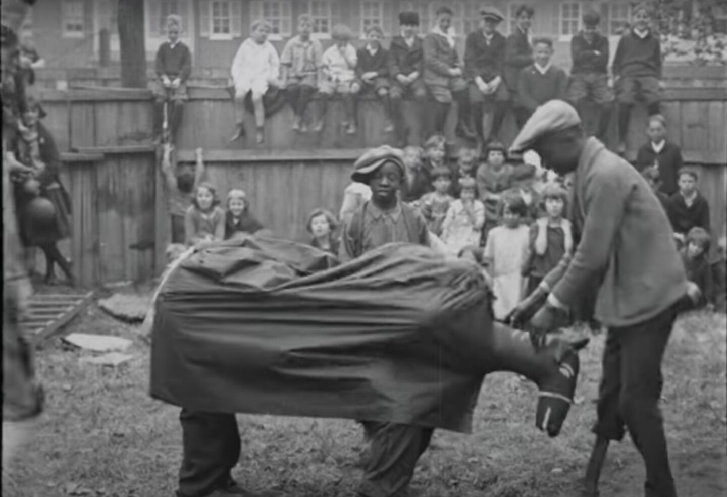 A man and his young helper put on a show for kids at a Pigtown school sometime between the 1920s and '30s.
