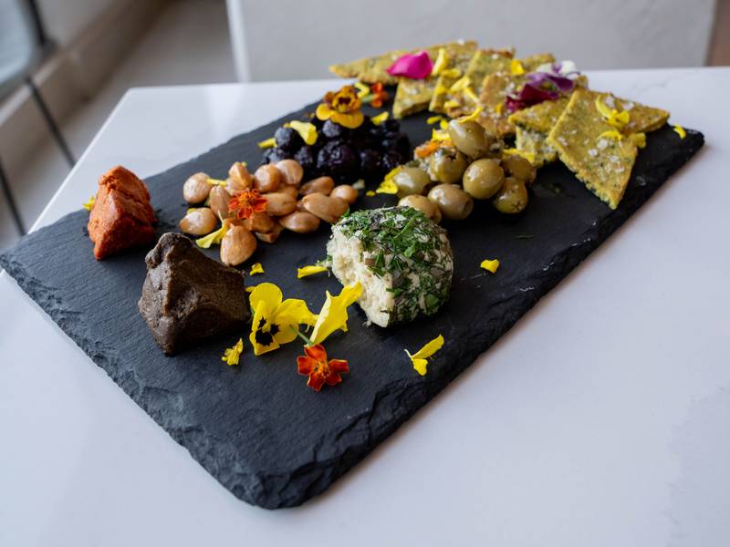 Artisanal Cheese Plate featuring pickles, jam and seedy crackers at Liora.