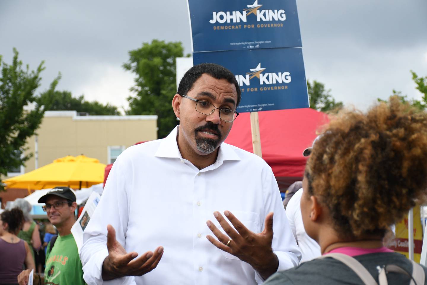 Maryland Democratic candidate for governor John King talks with voters at a farmers market in Baltimore's Waverly neighborhood on Saturday, July 16, 2022.