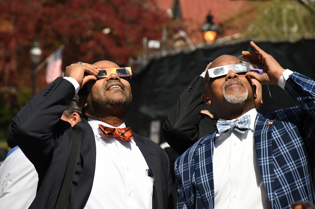 Sen. Charles Sydnor, left, and Sen. Ron Watson check out the partial solar eclipse outside the Maryland State House in Annapolis on Monday, April 8, 2024 -- which is also the final day of the annual legislative session.